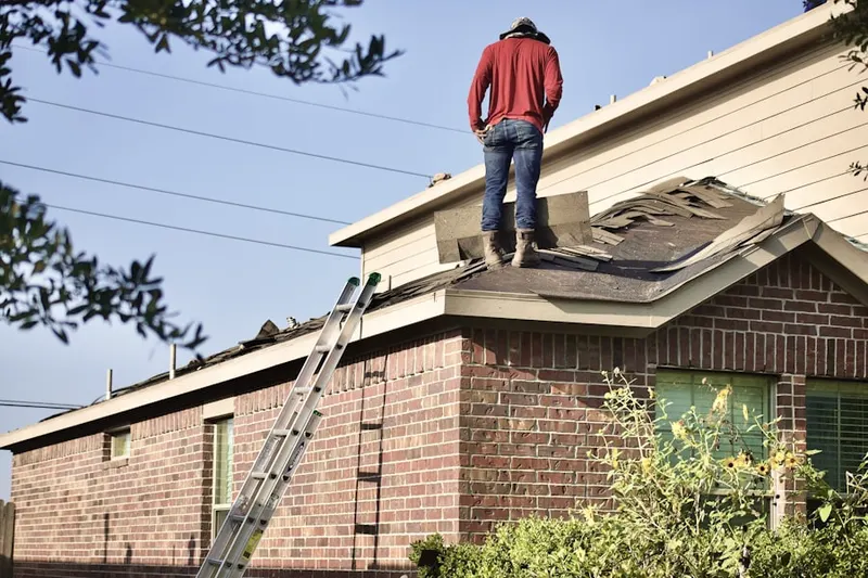 Professional roofer working on a residential roof in Foxfire